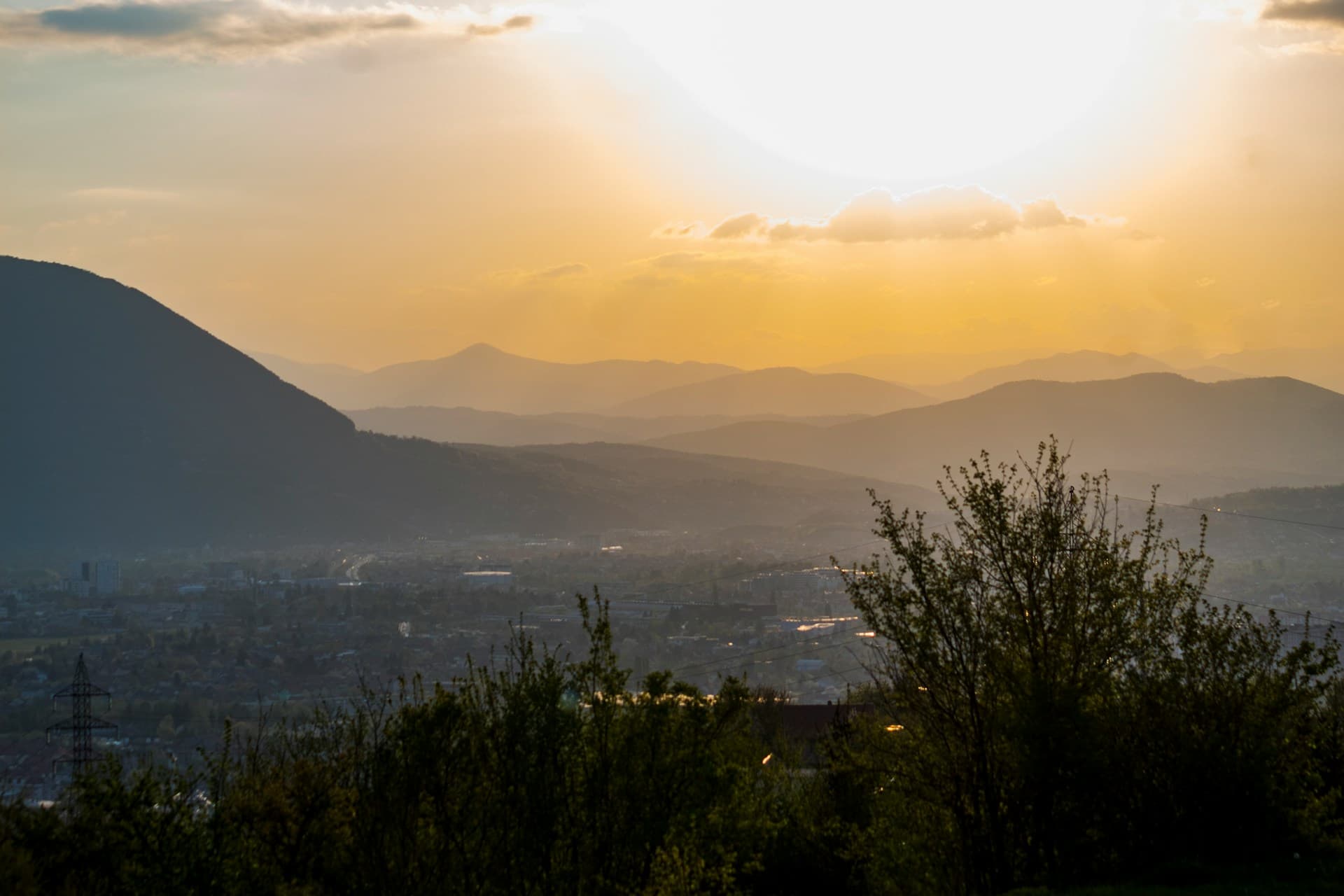 Mountain ridges and valley layers under low golden sidelight